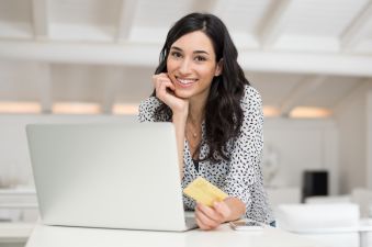 Young happy woman working on laptop