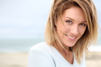 smiling middle aged woman on the beach
