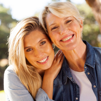 happy middle-aged mother with adult daughter