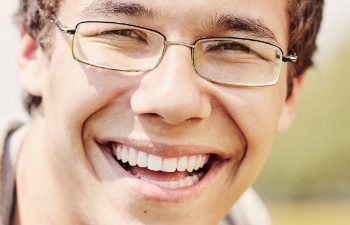 young man in glasses with a beautiful smile