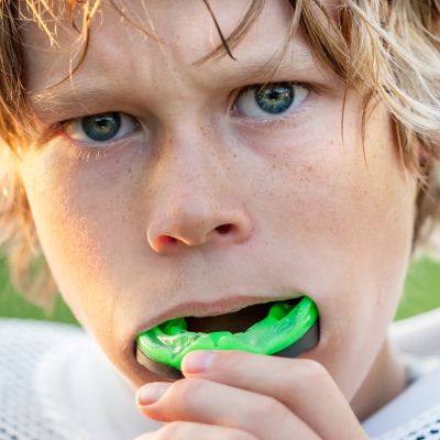 Boy putting in his athletic mouth guard