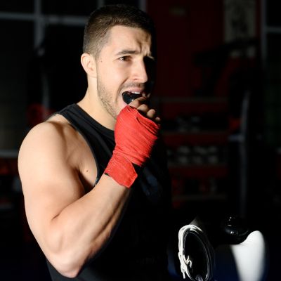 Boxing Fighter Putting On Mouthguard.