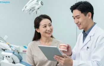 Dentist explaining dental implants to patient using tablet in modern clinic