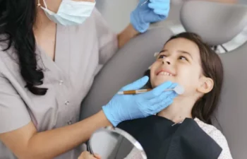 Smiling child receiving gentle dental checkup in modern clinic chair