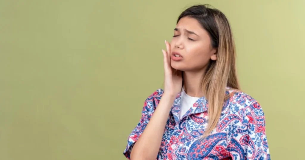 Woman holding ear and jaw in pain from possible ear infection
