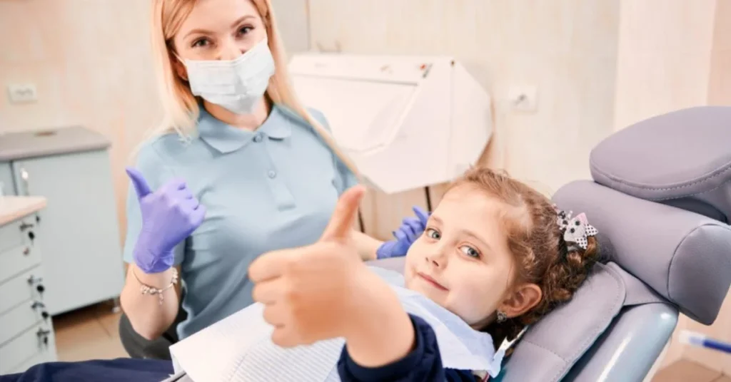 Childrens dentist visit cost in Roswell GA, child smiling in chair