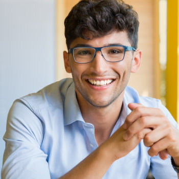 Young man wearing glasses Roswell Complete Dentistry patient care