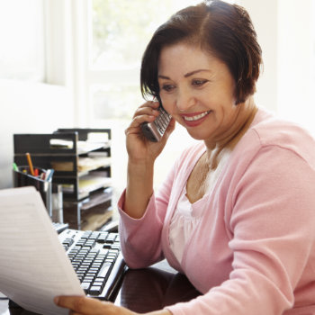 Senior Hispanic woman receptionist at Roswell Complete Dentistry