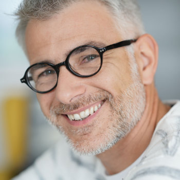 Handsome mature man with glasses Roswell Complete Dentistry care