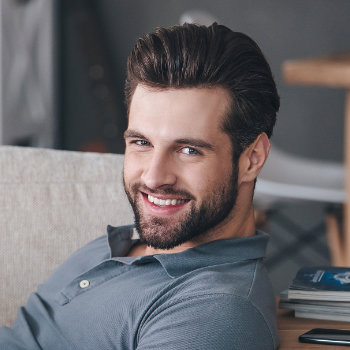 Smiling handsome businessman Roswell Complete Dentistry patient