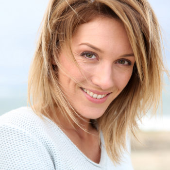 Mature blonde woman smiling Roswell Complete Dentistry patient
