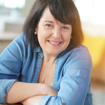 Mature brunette woman smiling Roswell Complete Dentistry care