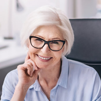 Smiling senior woman with glasses Roswell Complete Dentistry care