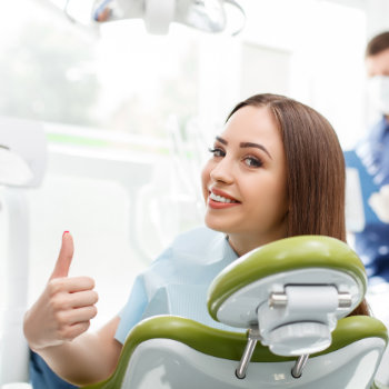 Complete Mouth Dental Implants Roswell happy patient smile chair