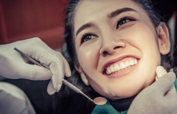 Woman smiling during a professional dental checkup at clinic