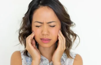 Woman with ear pain seeking TMJ Treatment relief